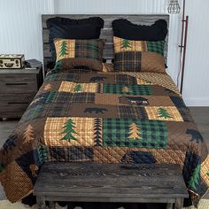 the bed is made up with brown and green quilts