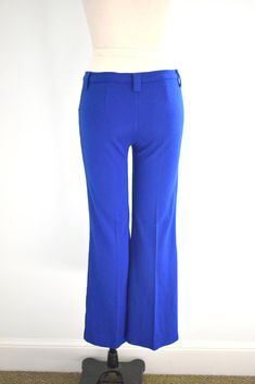 "Description: 1970s bright blue low rise pants. Cotton/polyester knit. Two hip pockets. Snap and nylon zipper closure. Belt loops that can fit a 1.75\" wide belt. Condition: In great condition, with no holes or stains. Designer: Sears Jr. Bazaar Stated Size: 9 Measurements: Waist: up to 30\" (these do not fit the narrowest part of your waist because they are low rise, so take that into account with fit) Hips: up to 36\" Rise: 9.5\" Inseam: 31\" Overall length: 39\" Circumference at hem: 20\" --- Mid-rise Blue Pants With Belt Loops, Blue Mid-rise Pants With Belt Loops, Stretch Blue Bottoms With Belt Loops, Blue Full-length Bottoms With Belt Loops, Retro Blue Straight Leg Pants, Retro High Waist Blue Pants, Retro Blue Bottoms With Belt Loops, Retro Blue Full-length Pants, Retro Stretch Blue Pants