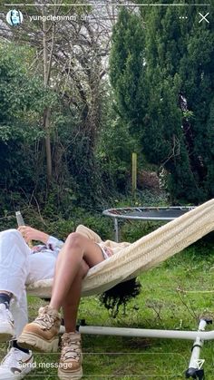 a person laying in a hammock on the grass