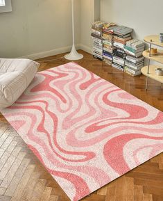 a pink and white rug on the floor in a living room with bookshelves