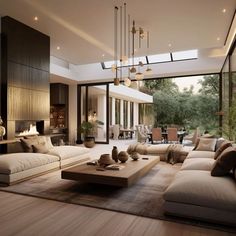 a large living room with couches and tables in front of glass doors that look out onto the outdoors