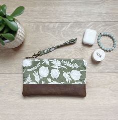 "Olive Green floral wristlet with faux leather. This small purse is perfect to carry all your essentials for a night out or shopping with the girls. It is also great to add to your diaper bag, tote bag or beach bag to contain your money and cards. It is so versatile and is made with quality materials to last. This makes a great teacher gift, bridesmaid gifts, birthday gift or just great for yourself! It measures 9\" W and 6\" tall. It is made with olive green floral fabric and beautiful brown fa Green Floral Fabric, Faux Leather Wristlet, Phone Wristlet, Diaper Bag Tote, Great Teacher Gifts, Wristlet Purse, Wristlet Clutch, Phone Pouch, Small Purse