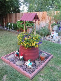 a potted planter filled with flowers in the middle of a yard