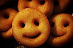 several donuts with smiley faces on them