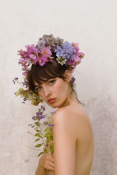 a naked woman with flowers in her hair