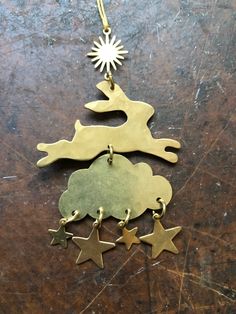 an ornament is hanging on a table with two stars and a dog in the shape of a christmas tree