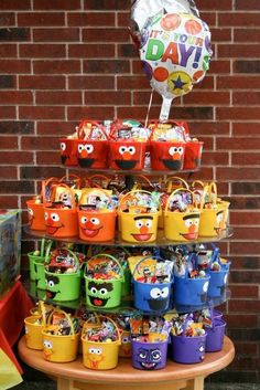 the birthday cake is decorated with colorful baskets and balloons for each child's birthday