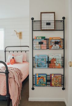 a bedroom with a metal bed and bookshelf