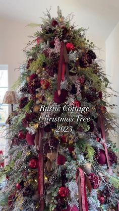 a christmas tree is decorated with red and green ribbons, bows, and other decorations