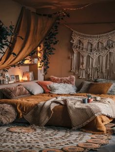 a bed with lots of pillows on top of it in a room filled with lights