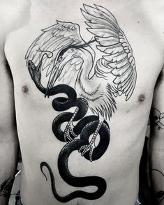 a man's chest with a snake and wings tattoo on his back, which is black and white