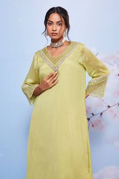 Mint A-line kurta with intricate yoke and sleeve hemline embroidery. Comes with palazzo.
Components: 2
Pattern: Embroidered
Type Of Work: Floral and Leaf Patterns
Neckline: Scalloped
Sleeve Type: Three Quarter
Fabric: Chiffon and Mulmul
Color: Green
Other Details: 
Side seam pocket kurta
Scalloped neckline
Occasion: Mehendi and Haldi - Aza Fashions Elegant Palazzo Set With Embroidered Neckline, Elegant Pista Green Dress For Navratri, Traditional V-neck Sets With Embroidered Neckline, Designer Embroidered Neckline Dress For Diwali, Bollywood Style V-neck Dress With Cutdana, V-neck Dress With Cutdana For Festive Season, Bollywood Wedding Dress With Embroidered Neckline, Festive Straight Kurta Tunic With Embroidered Neckline, Green Straight Kurta Sets With Embroidered Neckline