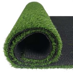 a roll of artificial grass on top of a mat