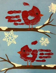 two red birds perched on branches with snowflakes in the background and one bird sitting on top of another branch