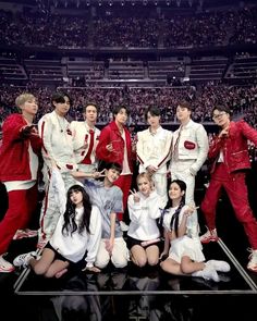 a group of young men and women posing for a photo in front of an audience