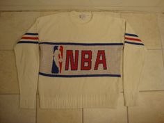 a white sweater with the word nba on it