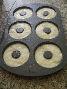 a muffin pan filled with batter on top of a counter