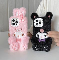 two cell phones that are shaped to look like animals, one is pink and the other is black