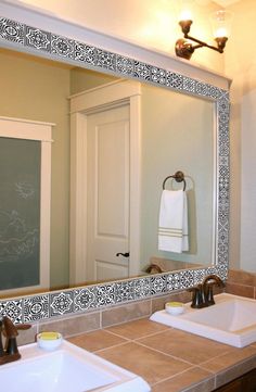 a bathroom with two sinks and a large mirror over it's counter top area