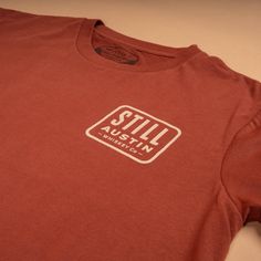 Still's classic stacked logo on our 'Brick Red' Feather Grass tee. Classic Red Fitted T-shirt, Classic Fitted Red T-shirt, Classic Red Cotton T-shirt, Red Classic Cotton T-shirt, Casual Red T-shirt With Branding, Holiday Chaos, Directional Signs, Red Feather, Red S