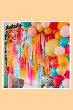 a woman standing in front of balloons and streamers