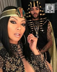 a man and woman dressed up in egyptian garb standing next to eachother