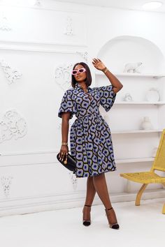 This LALA African Print Flare Sleeve Button Dress is sure to add a lil' va-va-voom to your wardrobe! Its high-quality fabric, fierce pocket detailing, and 'Oh-so-fabulous' flared sleeve make it the perfect fit for any stylish slay queen! Add your favorite slides and a mini bag for a legendary look – we guarantee you won't regret it! FEATURES. 100% African Wax Cotton Dress is Unlined Flare sleeves Button-down at the front. Matching belt Collar neckline Side pockets Model Is Wearing a Medium Dress Fit And Flare Ankara Dress, Flare Sleeves Dress, Cotton Stylish Dresses, Wax Dress African, Bitenge Fashions For Ladies, African Shirt Dresses For Women Classy, Flared Dresses Classy, Ankara Flare Dress Styles, Modern Ankara Dress Styles