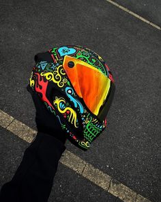 a person wearing a colorful helmet on the street