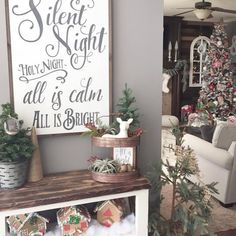 a living room filled with furniture and christmas decorations on top of a wooden shelf next to a