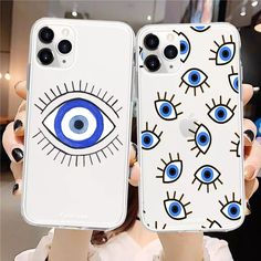 two cases with blue eyes on them are held up in front of a woman's face