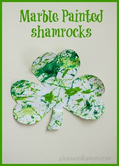 a shamrock made out of paper with the words marble painted shamrocks written on it