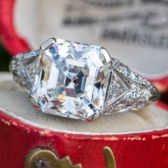 an old - fashioned diamond ring sits on top of a box