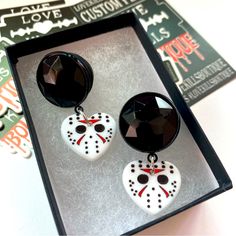 the earrings are decorated with white and black beads, which have red accents on them