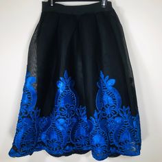 Black A-Line Skirt With Beautiful Blue Flor Embroidery. Nwt. Wear With Boots, Sandals, Or Jazz Up With Heels. Make This Your Statement Piece! Approximate Measurements: Waist: 27-28” (Please Look At Measurements In Picture; Waistband Has A Curvature Because It’s Elastic, When Held Straight Without Over Stretching, It Measures At Approximately 27-28”) #1172 Blue Embroidered Mini Skirt, Black Embroidered Flowy Skirt, Black Floral Embroidered Skirt For Parties, Black Skirt With Floral Embroidery For Party, Flowy Black Embroidered Skirt, Fitted Blue Skirt With Floral Embroidery, Black Floral Embroidery Skirt For Party, Black Floral Embroidery Party Skirt, Embroidered Black Party Bottoms