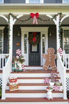 a house decorated for christmas with gingerbreads and candy canes on the front porch