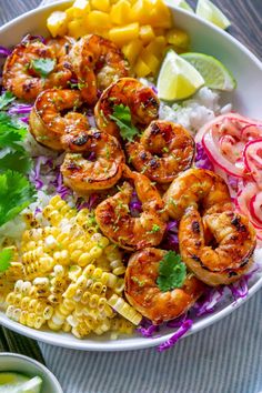 a white bowl filled with shrimp and corn