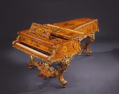 an ornately carved grand piano on display