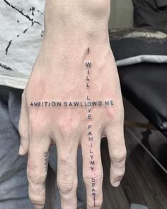 a person's hand with the words written on it and an inscription in black ink