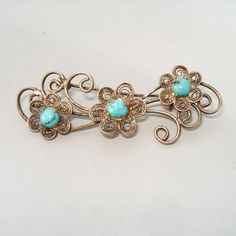 Filigree floral design vintage brooch made of silver with turquoise cabochons, C-clasp to the backside, marked 925. Good vinatge condition, with beautiful patina. Dimensions: 5x2 cm Weight: 10 gr Elegant Turquoise Brooches For Collectors, Handmade Vintage Turquoise Brooches, Vintage Brooch, Silver Turquoise, Design Vintage, Turquoise Sterling Silver, Vintage Brooches, Vintage Sterling Silver, Patina