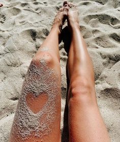 a person laying on top of a sandy beach