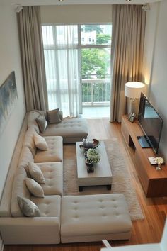 a living room filled with furniture and a flat screen tv