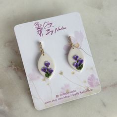 🌸 Purple violet delicate florals on a creme background -  Each petal is made from polymer clay and placed one by one with a needle, long process that requires a lot of patience. Perfect earrings for flower lover who value handmade creations, thoughtful birthday present. 🌸 February birth flower - Violets are known for signifying strength, gracefulness, leadership, and royalty, representing many individuals born in February who have great courage and determination. Violets also symbolise delicat Creme Background, February Birth Flower, February Birth Flowers, Floral Polymer Clay, White Jewelry Box, Earrings Purple, Purple Violet, Branded Gifts, White Jewelry