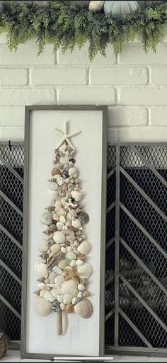 a christmas tree made out of seashells on a mantle