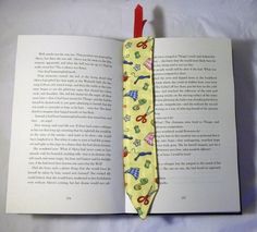 an open book with a tie on it