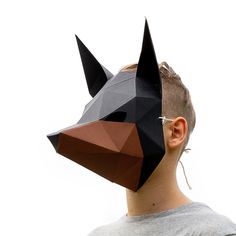 a man wearing a paper mask with an animal's head on top of it