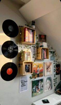 there are many records hanging on the wall next to each other in this home office