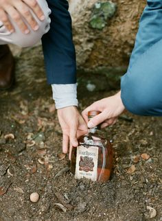 two people reaching for something in a jar