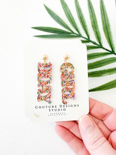 These super fun and sparkly Birthday Girl Earrings are perfect for gifting or keeping for yourself!  They are such a fun way to celebrate a birthday! Each pair of earrings are made using a a bright multi colored glitter acrylic that says BDAY and GIRL. The total length of these earrings measure approximately 2 inches long and .6 inches wide. They are set using your choice of Stainless Steel Silver or Gold Ball Posts OR lead free and nickel free ear wires (suitable for even sensitive ears) in a G Sparkly Birthday, Birthday Earrings, Birthday Glitter, Glitter Acrylic, Glitter Earrings, Glitter Acrylics, Girls Earrings, Sensitive Ears, Birthday Girl