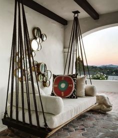 a white couch sitting on top of a wooden swing