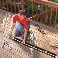 a man working on a wooden deck with tools